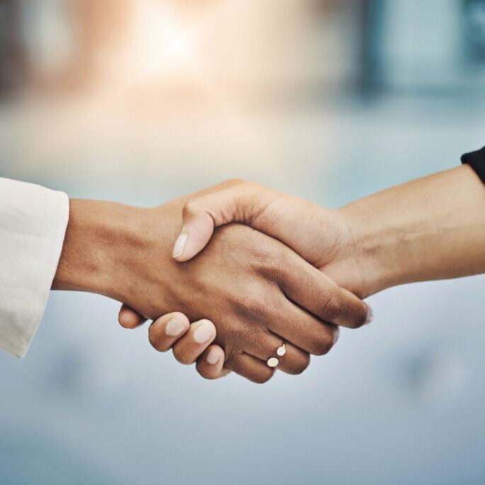 An agreement has been reached. Closeup shot of two businesswomen shaking hands in an office