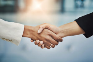 Contact Kimberly E. Lorenz Esq and Lorenz Mediation for help with your agreement. Closeup shot of two businesswomen shaking hands.